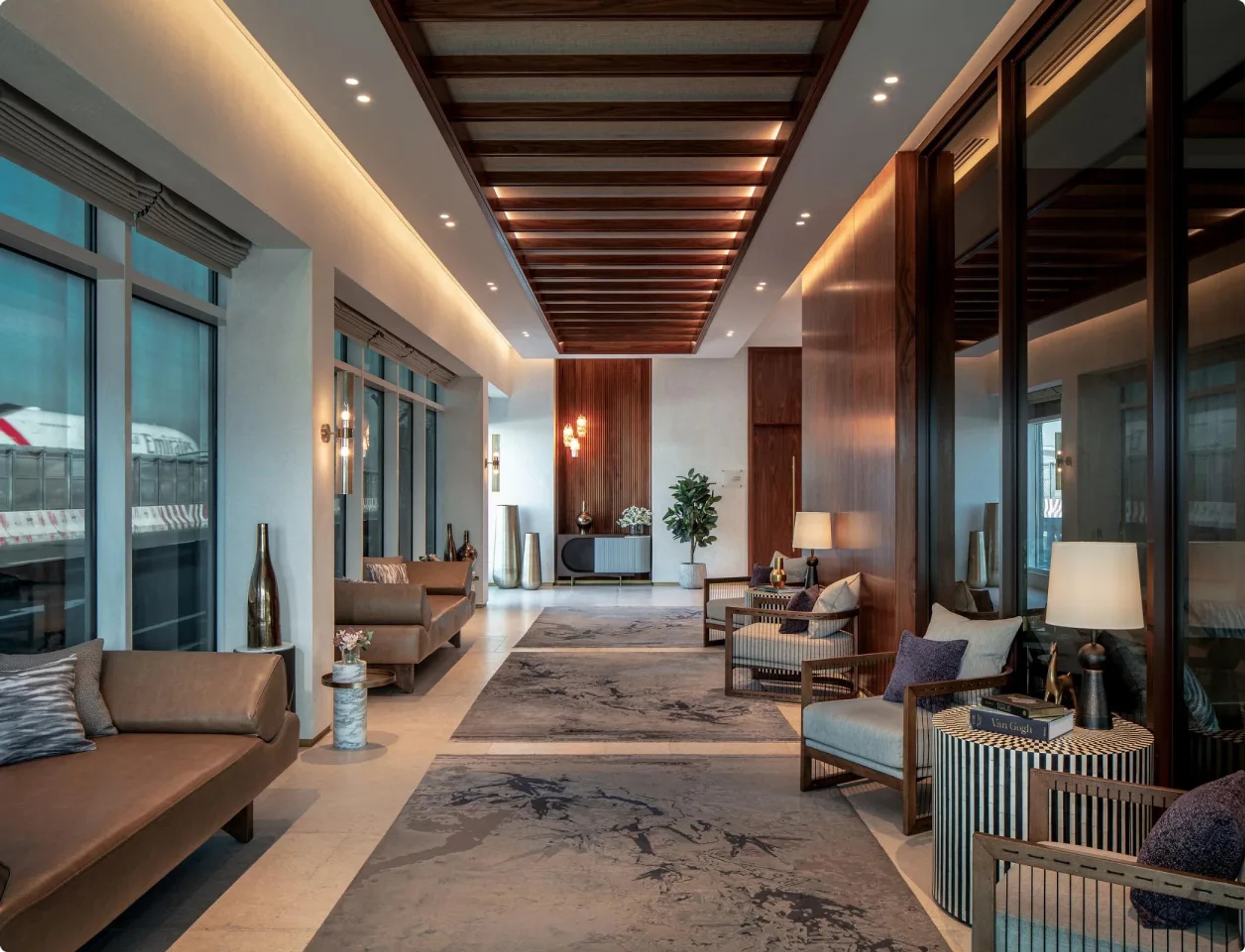 A VIP airport lounge at Al Majlis with an Emirates aircraft outside